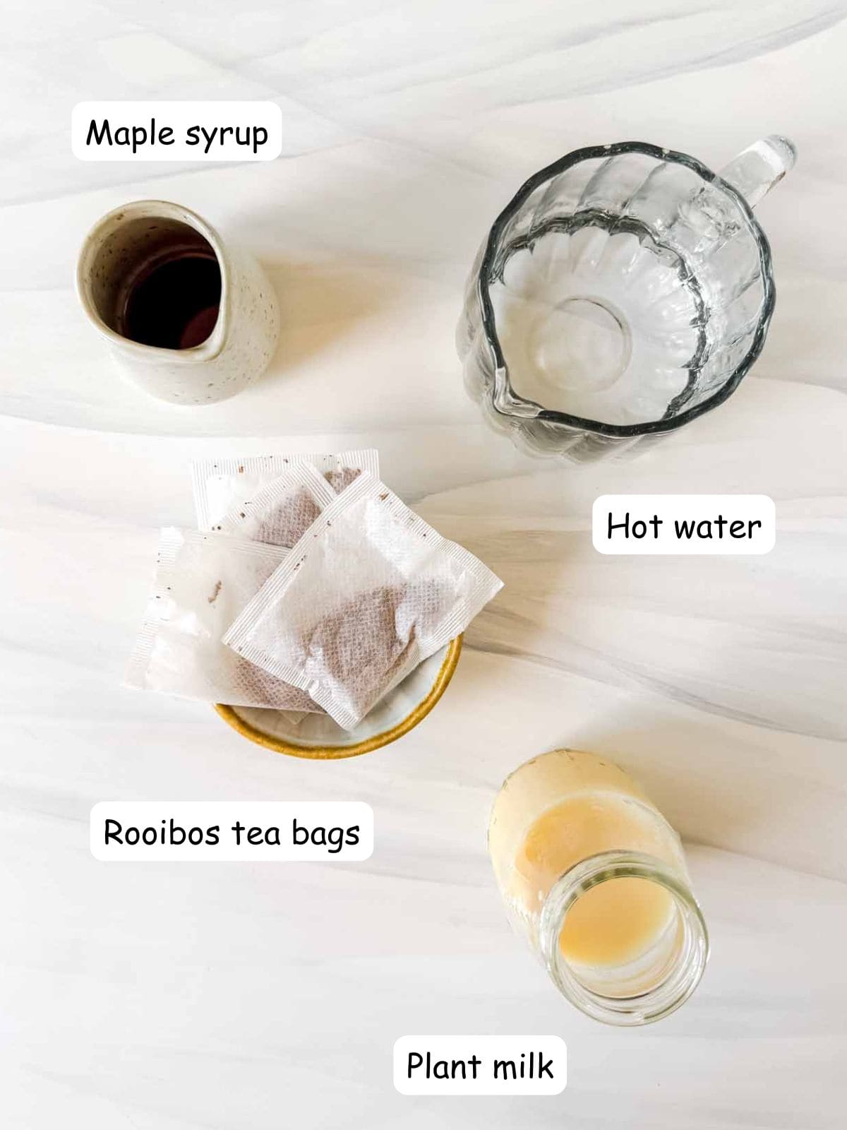 individually labelled rooibos tea bags, plant milk, maple syrup and hot water.