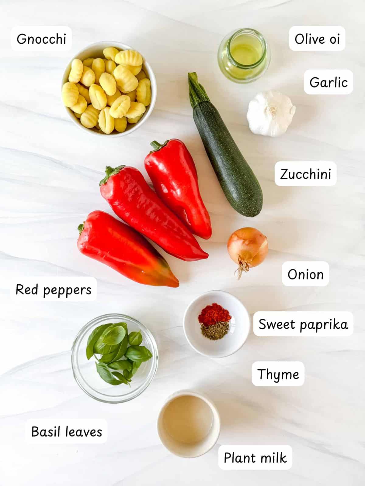 individually labelled red peppers, gnocchi, basil leaves, olive oil, garlic, zucchini, onion, sweet paprika, thyme and plant milk.