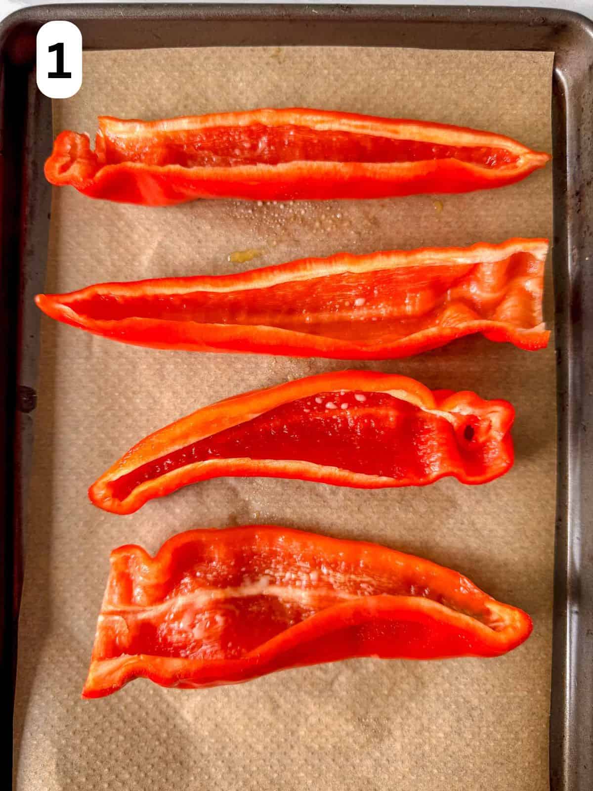 pointed red peppers on a baking sheet lined with parchment paper labelled number one.