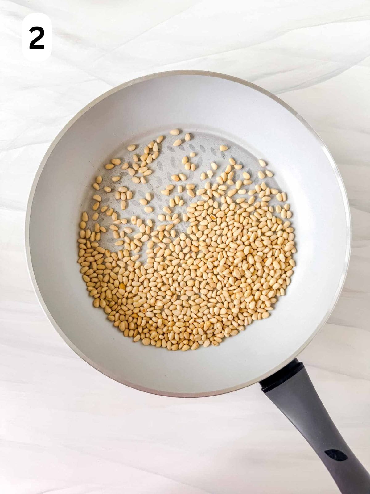 pine nuts in a skillet labelled number two.
